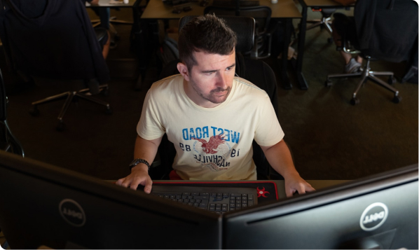 Man starting at dual monitors